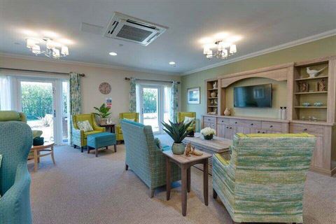 Care home lounge with blue and green chairs